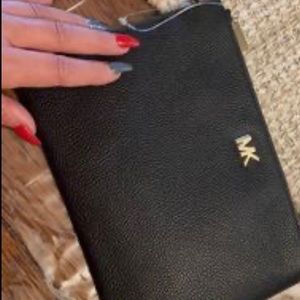 Black larger size wristlet. New. Still has plastic tie attached that tag was on.